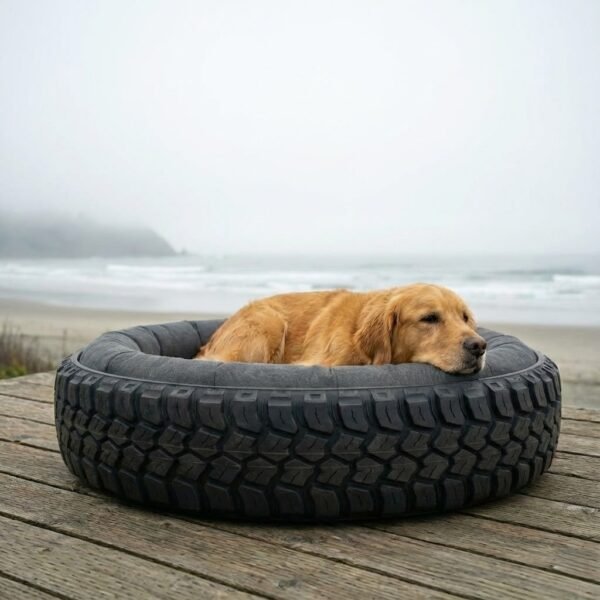 Golden Retriever sleeping in Treads2Tails upcycled tyre dog bed with dark waterproof canvas insert on an outdoor wooden deck in foggy weather